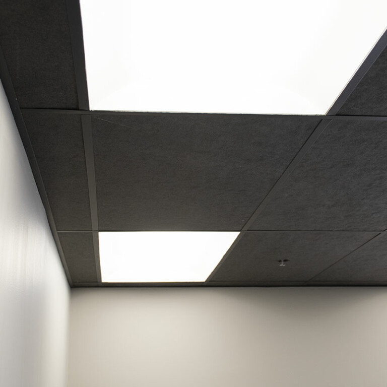black acoustic ceiling tiles installed in office